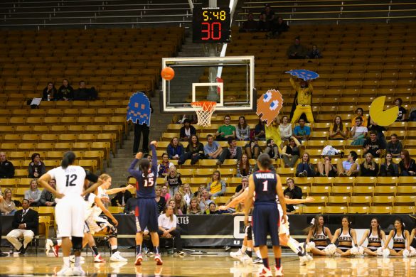 Arizona guard Keyahndra Cannon attempts a free throw while members of the C-Unit attempt to distract her with Pac-man fatheads. (Nigel Amstock/CU Independent)