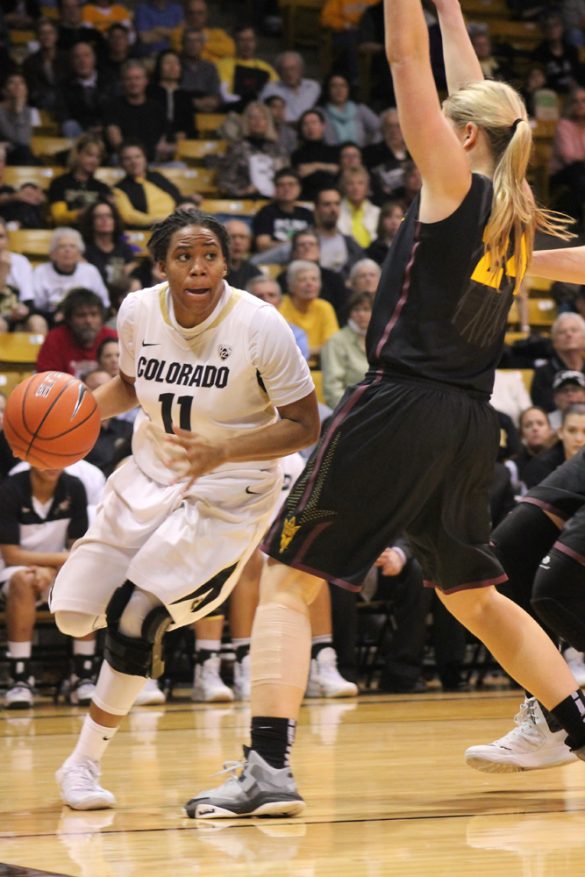 Colorado senior guard Brittany Wilson (11) runs the ball towards the net. Wilson scored 12 points out of the team's 66 point game. (Maddie Shumway/CU Independent)