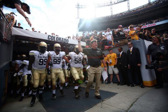 Coach Mike MacIntyre leads the Colorado team onto the field at Mile High in Denver on Sept. 1, 2013. (Nate Bruzdzinski/CU Independent)