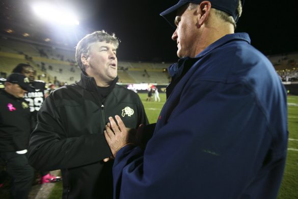 Colorado head coach Mike MacIntyre, left, shakes hands with Arizona head coach Rich Rodriguez after the Arizona WIldcats won 44-20 at Folsom Field, Saturday, Oct. 26, 2013. (Kai Casey/CU Independent)