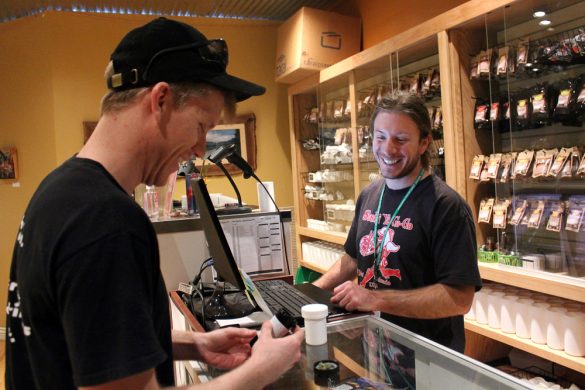 Justin Lapenter, right, a bud tender, and Chris Horner, a Colorado State graduate who now lives in Niwot, share a laugh at the Terrapin Care Station, Tuesday, Feb. 18, 2014, in Boulder, Colo. The Terrapin Care Station, located at the corner of Folsom Street and Canyon Boulevard, was the first recreational pot shop to open in the city of Boulder. (Kai Casey/CU Independent)