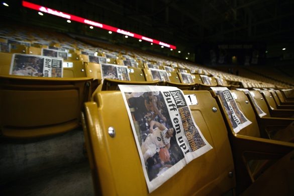 The front page of the game day edition of the Colorado Daily sits on every seat in the first 15 rows of the east side of the Coors Events Center for students to use during the College GameDay broadcast. (Kai Casey/CU Independent)