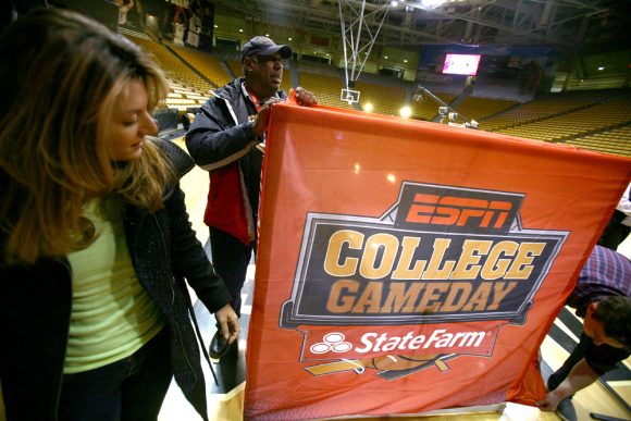 ESPN College GameDay crew set up a banner on the court at the Coors Events Center. (Kai Casey/CU Independent)