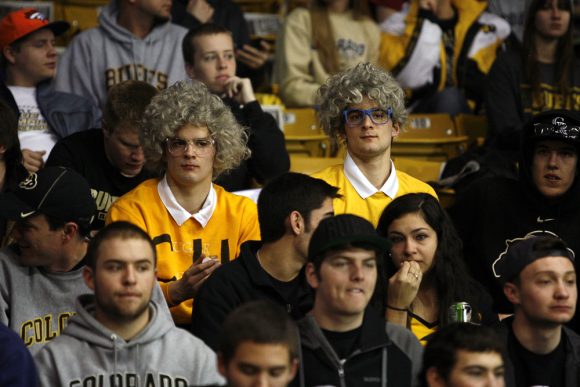 Two Colorado fans sit in the stands dressed as "The Twins," the two eighty-eight year old ladies who attend every CU sporting event, during the ESPN College GameDay broadcast at the Coors Events Center, Saturday, Feb. 22, 2014, in Boulder, Colo. (Kai Casey/CU Independent)