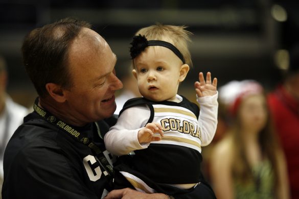 Colorado athletic director Rick George plays with his granddaughter Harper during the ESPN College GameDay broadcast at the Coors Events Center, Saturday, Feb. 22, 2014, in Boulder, Colo. (Kai Casey/CU Independent)