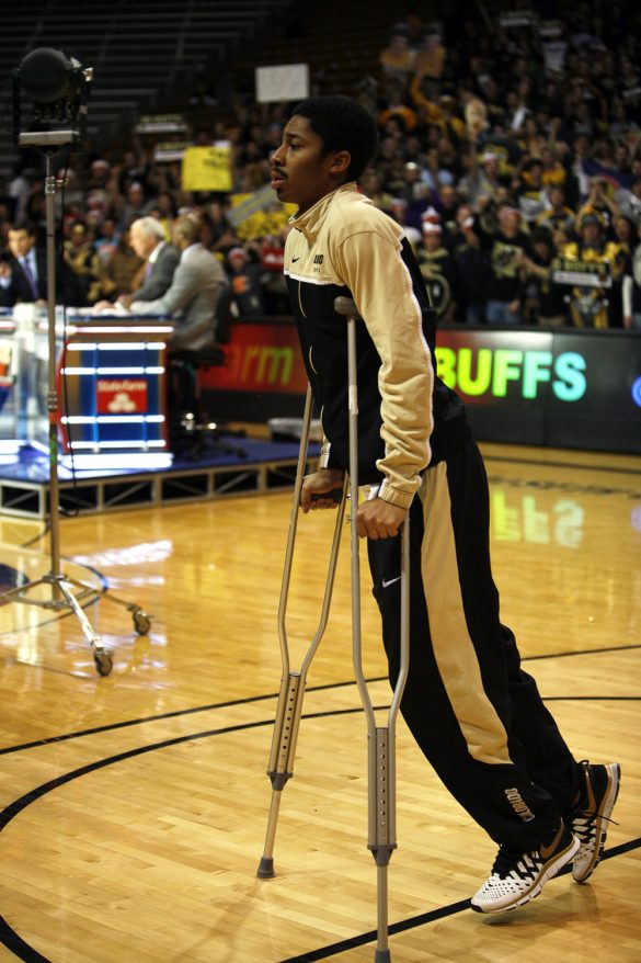 Colorado junior guard Spencer Dinwiddie walks off the court on crutches after on interview on the ESPN College GameDay broadcast at the Coors Events Center, Saturday, Feb. 22, 2014, in Boulder, Colo. Dinwiddie tore his ACL against Washington back in January and is out for the year. (Kai Casey/CU Independent)