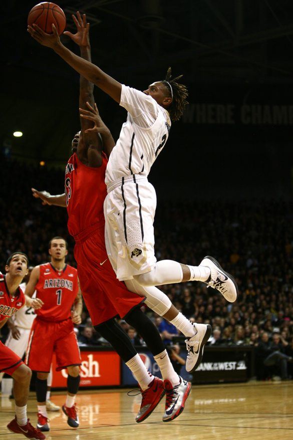Colorado forward Xavier Johnson (2) jumps for a layup past an Arizona defender during an NCAA college basketball game between the Colorado Buffaloes and the No. 4 Arizona Wildcats at the Coors Events Center, Saturday, Feb. 22, 2014, in Boulder, Colo. (Kai Casey/CU Independent)