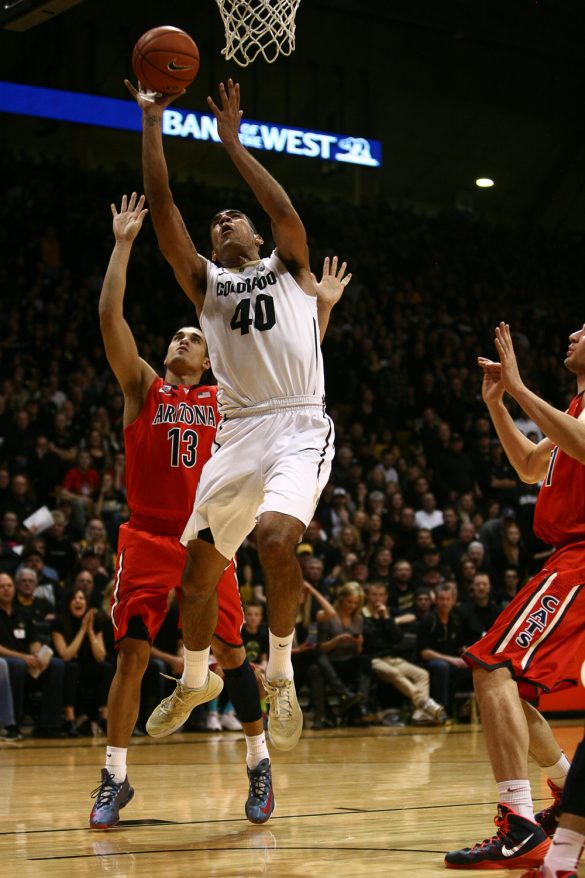 Colorado forward Josh Scott (40) lays the ball in past Arizona's Nick Johnson (13) during an NCAA college basketball game between the Colorado Buffaloes and the No. 4 Arizona Wildcats at the Coors Events Center, Saturday, Feb. 22, 2014, in Boulder, Colo. (Kai Casey/CU Independent)