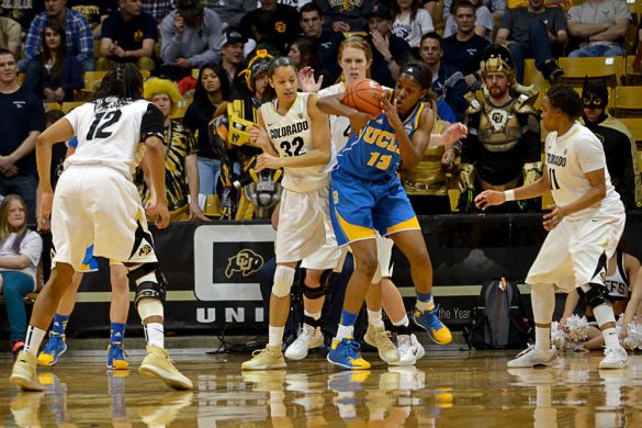 UCLA junior center Luiana Livulo (13) grabs a rebound in front of Colorado's Arielle Roberson (32) and Rachel Hargis (40) on Friday. (Elizabeth Rodriguez/ CU Independent)