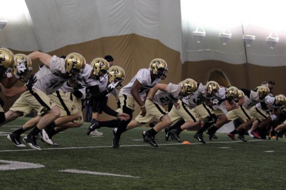 The defensive unit runs sprints at the end of practice on March 7, 2014. (Matt Sisneros/CU Independent)