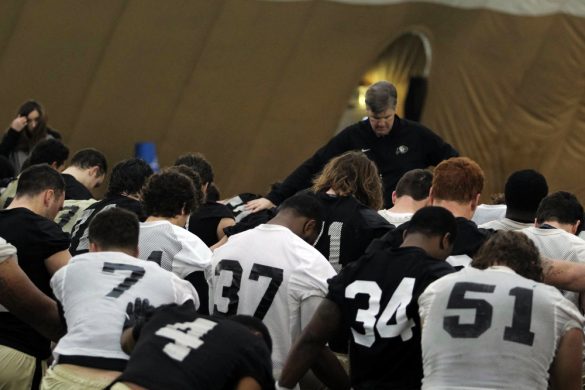 Head coach Mike MacIntyre leads a prayer at the end of practice on March 7, 2014. (Matt Sisneros/CU Independent)