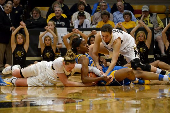Colorado's Jen Reese, left, and Haley Smith, right, struggle for possession of the ball with a UCLA player at Friday night's game. (Elizabeth Rodriguez/ CU Independent)