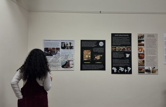 CU Boulder student viewing Know Your Nosh: Food, Jewishness, & Identity exhibit in Norlin Library. (Lucy Adlen/CU Independent)
