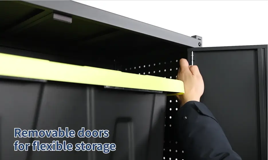 Hand adjusting removable door on black pegboard storage cabinet in bright setting