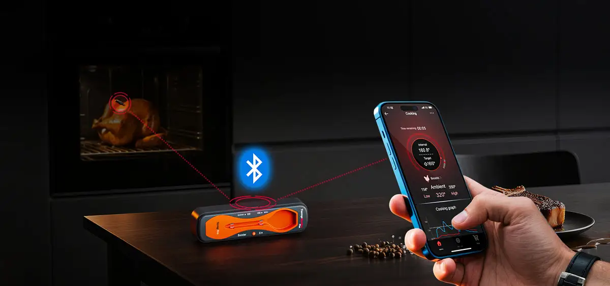 Bluetooth meat thermometer showing cooking progress on smartphone near oven with roasted turkey