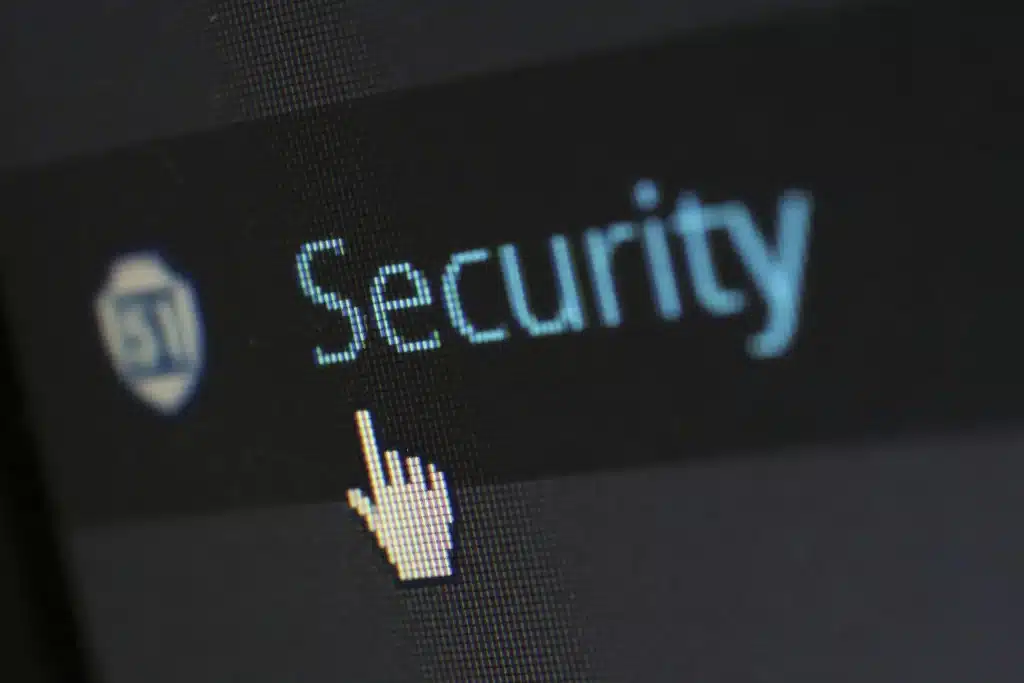 Cursor pointing at word "Security" on a computer screen displaying a dim interface
