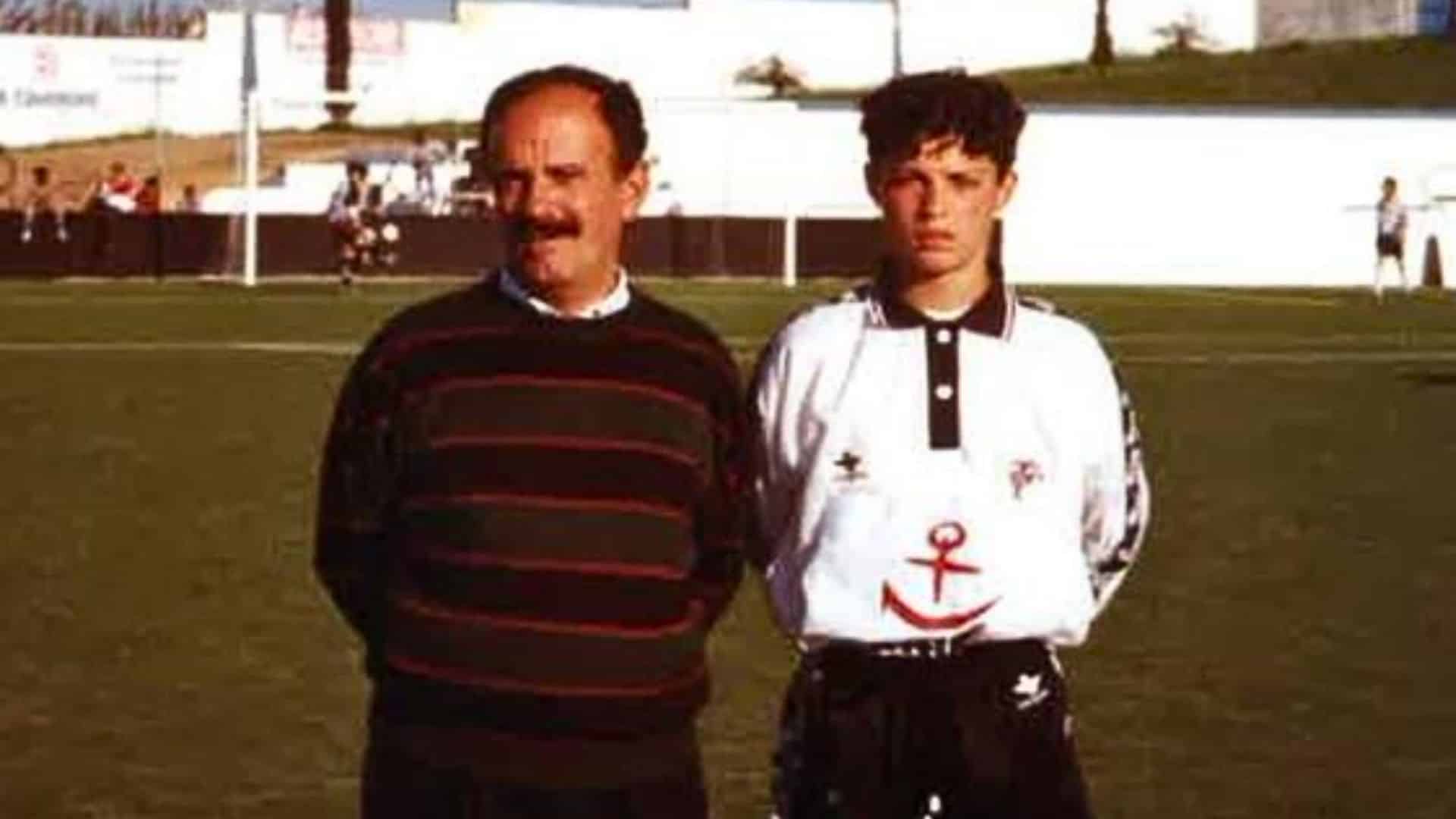 Cristiano Ronaldo at 12 in Lisbon Sporting CP, posing with an adult on a football pitch