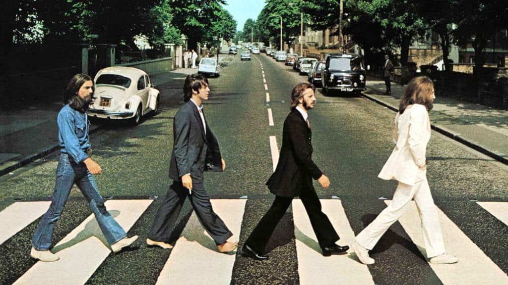 Iconic Abbey Road photo of The Beatles walking across a zebra crossing in London, 1969.