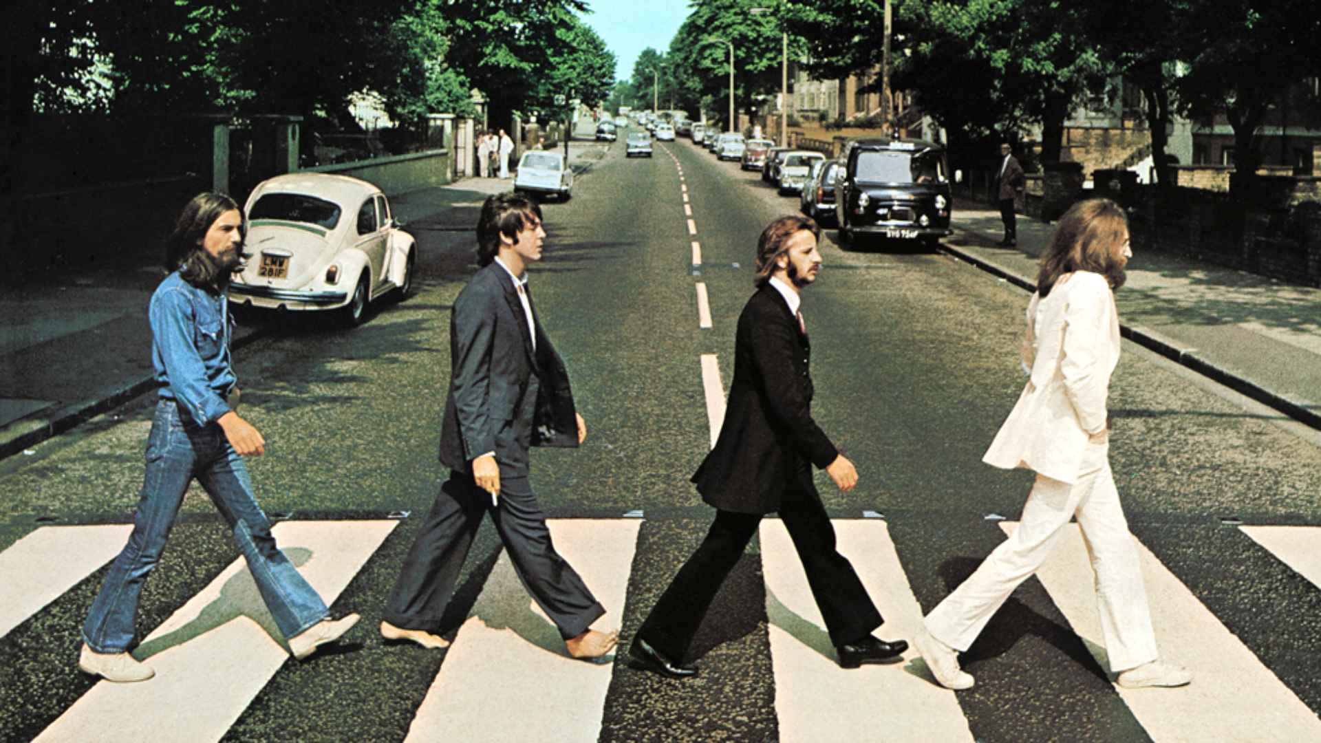 Iconic Abbey Road photo of The Beatles walking across a zebra crossing in London, 1969.