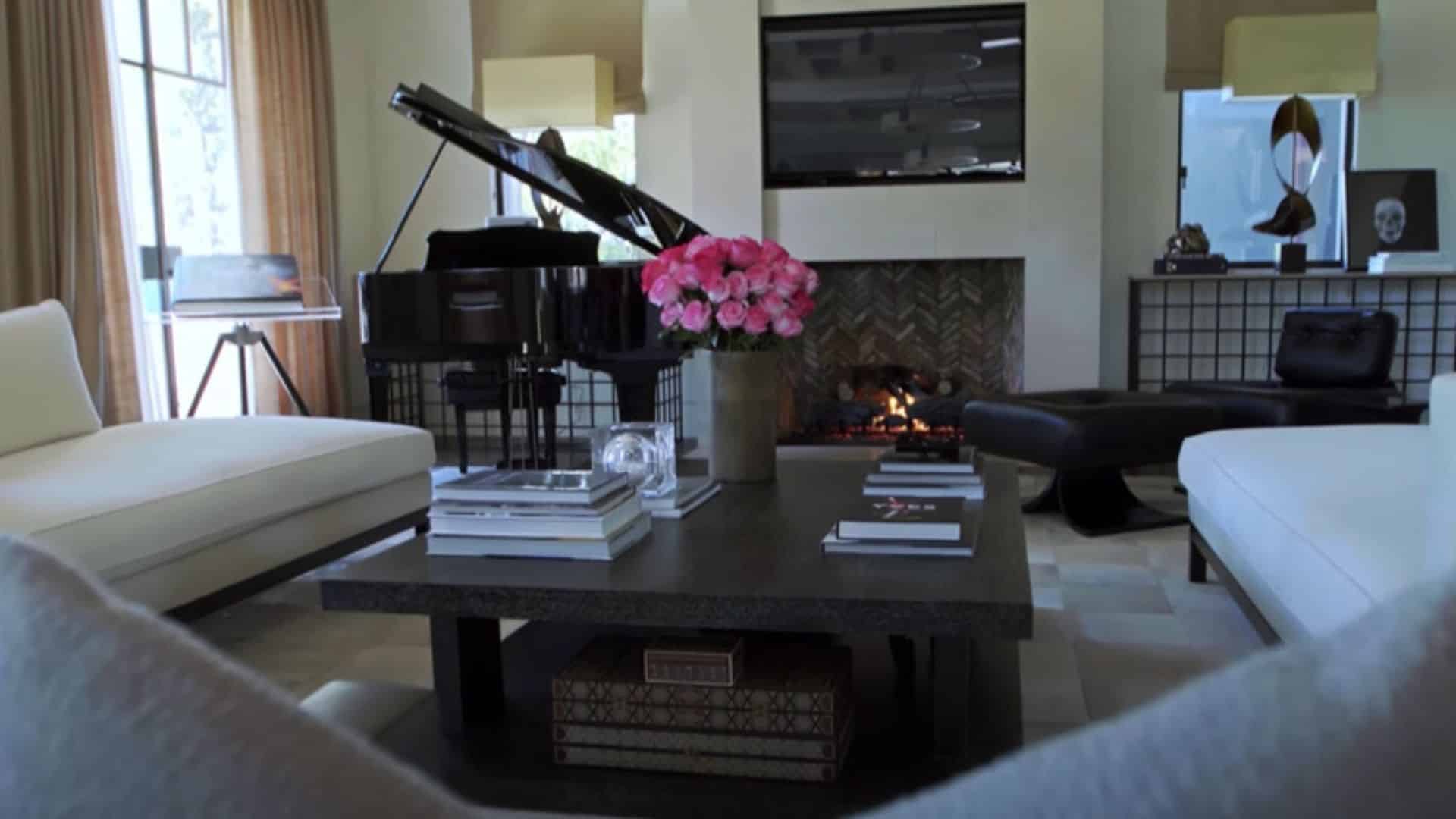 Kourtney Kardashian living room limestone fireplace floor-to-ceiling windows Calabasas home