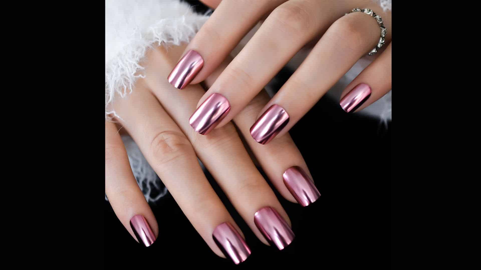 A close-up of Metallic Chrome Nails with a sleek, reflective finish and a silver ring