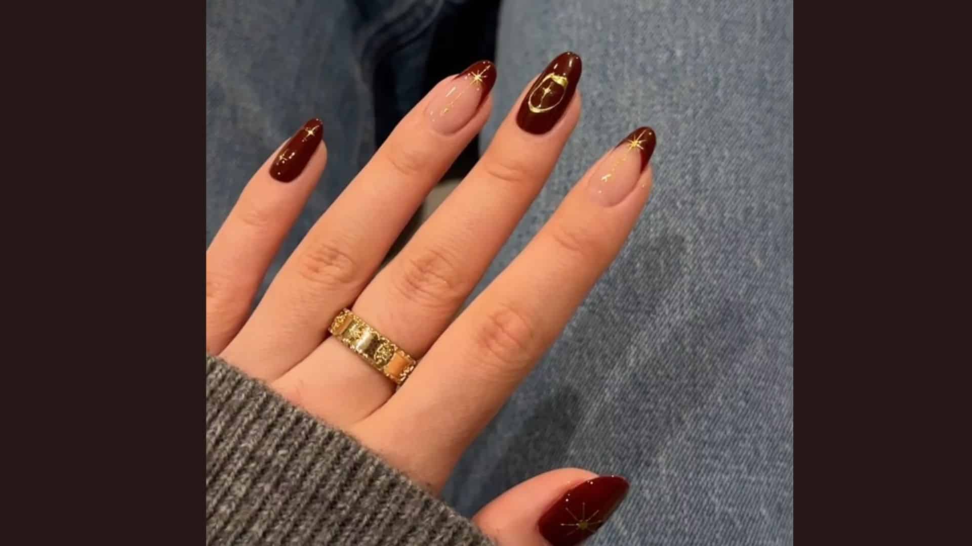 A hand with Matte Burgundy Nails and Gold Tips, featuring a sleek matte finish with a touch of gold at the tips