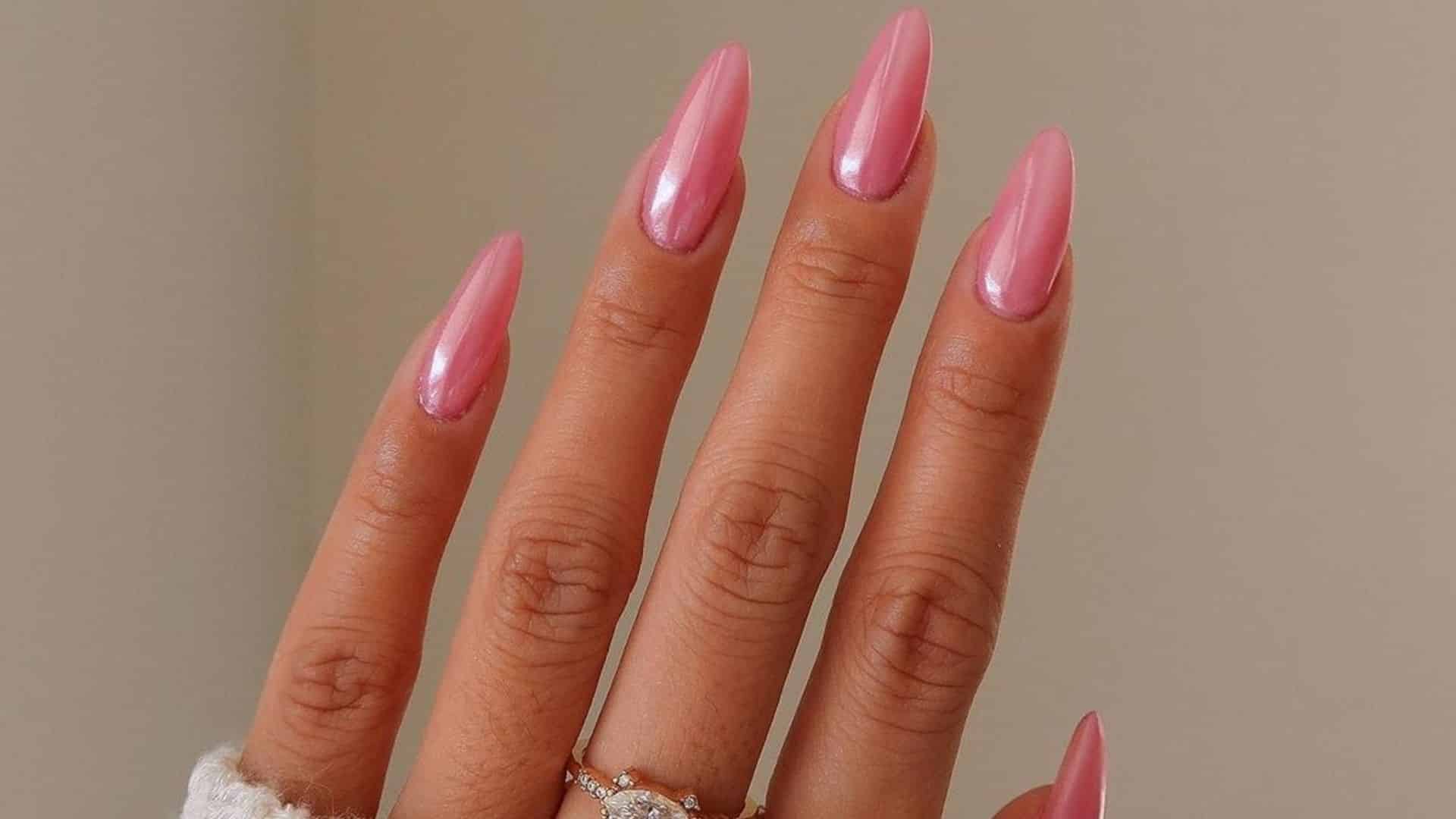 A hand with Neon Pink Nails, featuring a bright and bold color