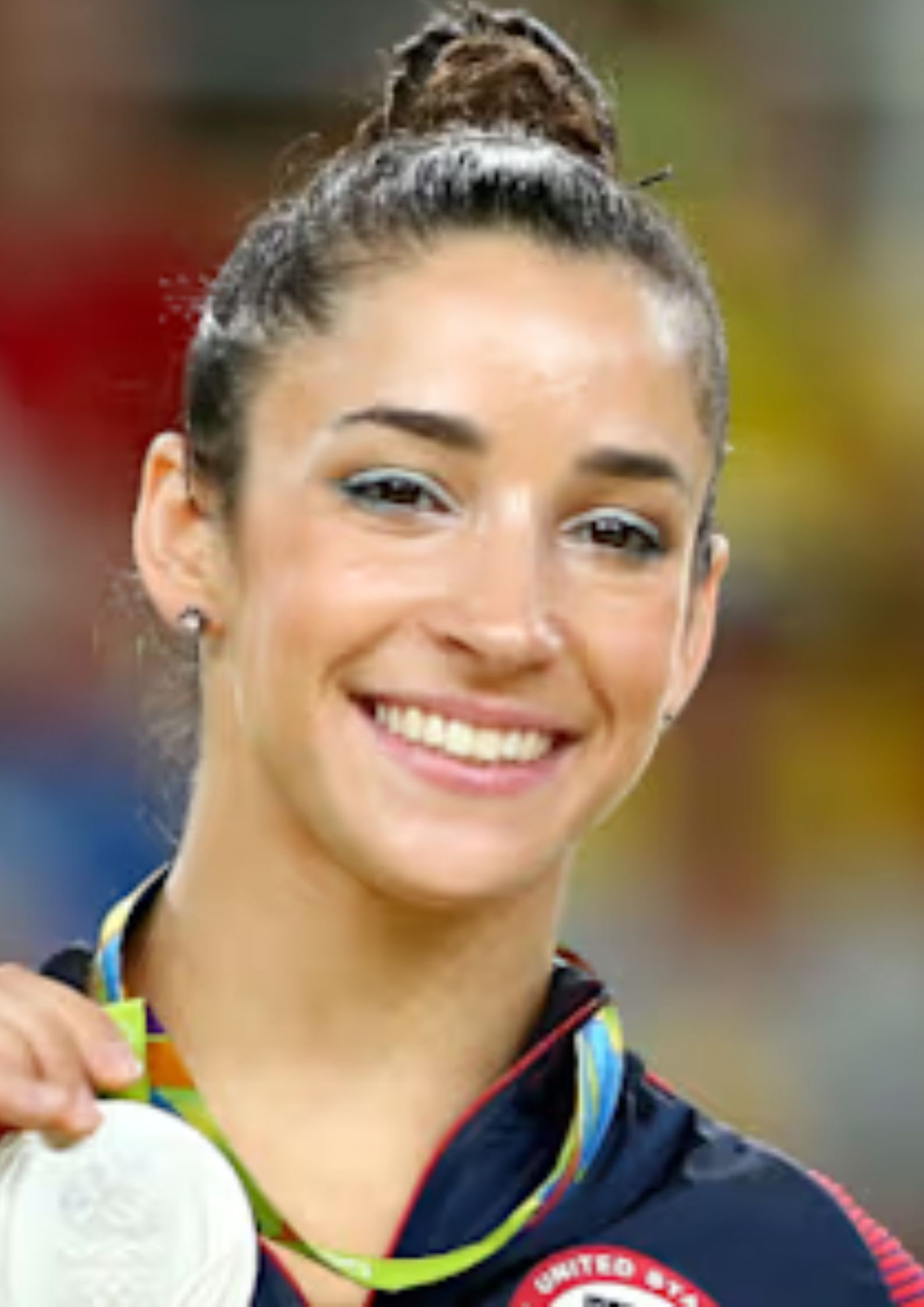 Aly Raisman holding an Olympic medal, American Jewish gymnast and advocate for athlete safety who competed for the United States (1)