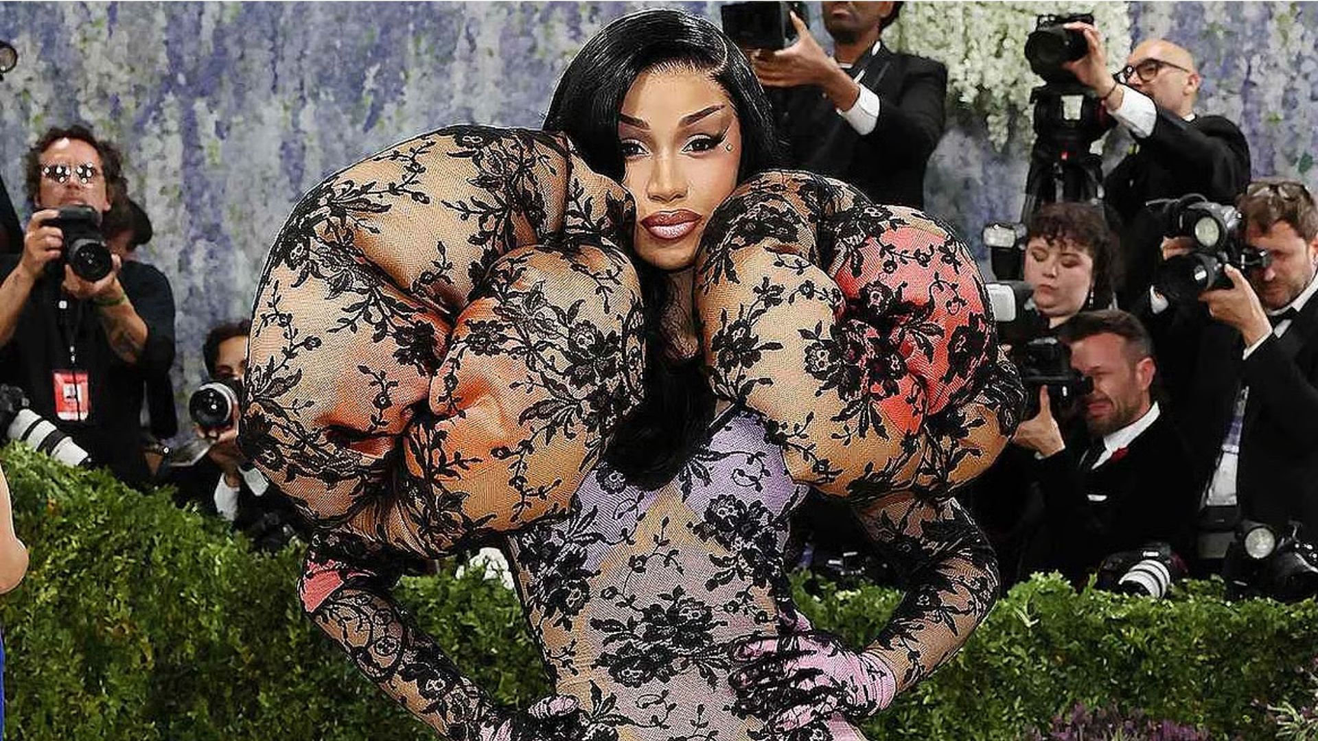 Cardi B wearing a dramatic lace-patterned couture gown with oversized sculptural sleeves at the Met Gala