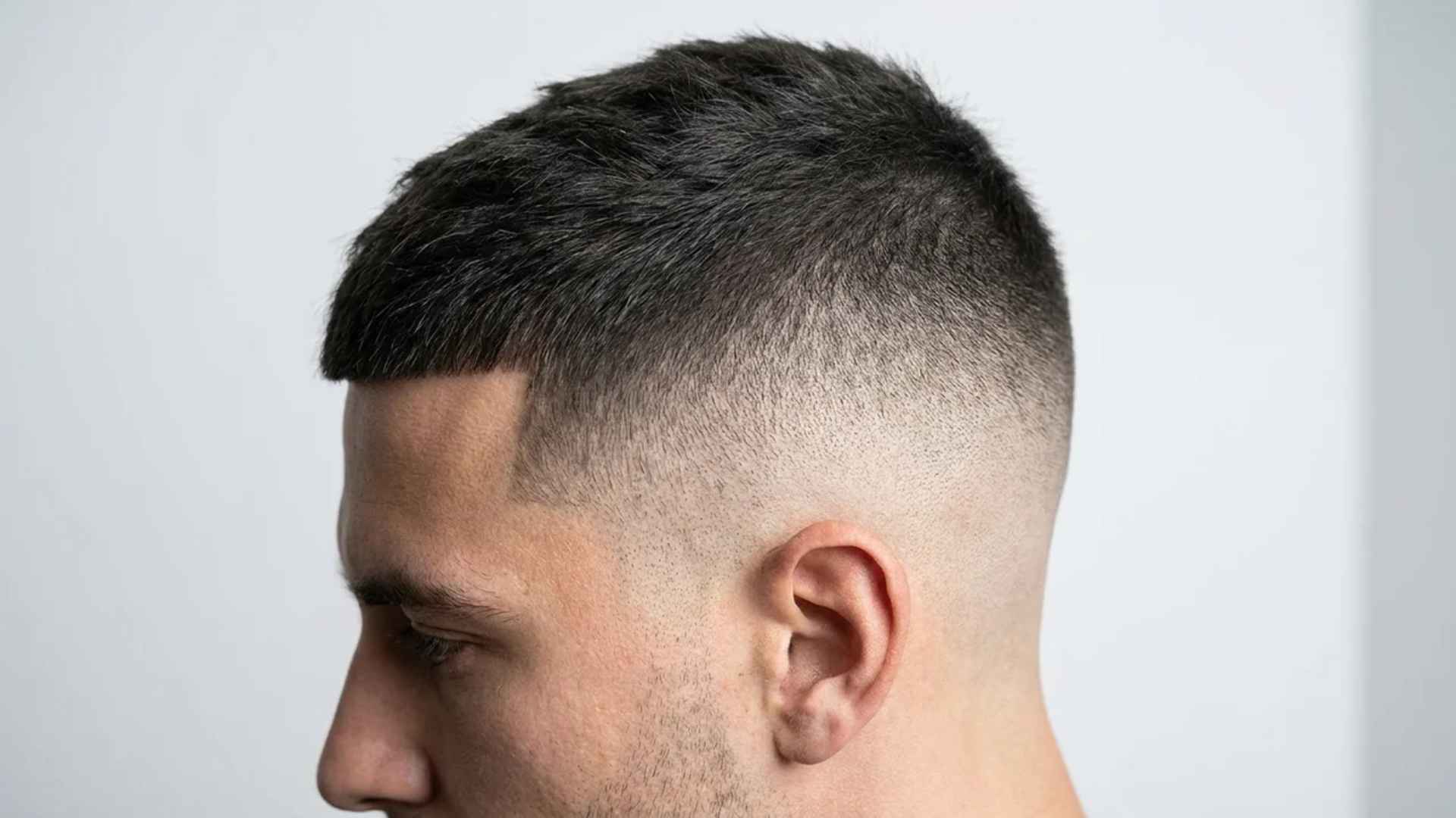 Grade 2 short cropped top with zero skin fade, bare sides razor clean.