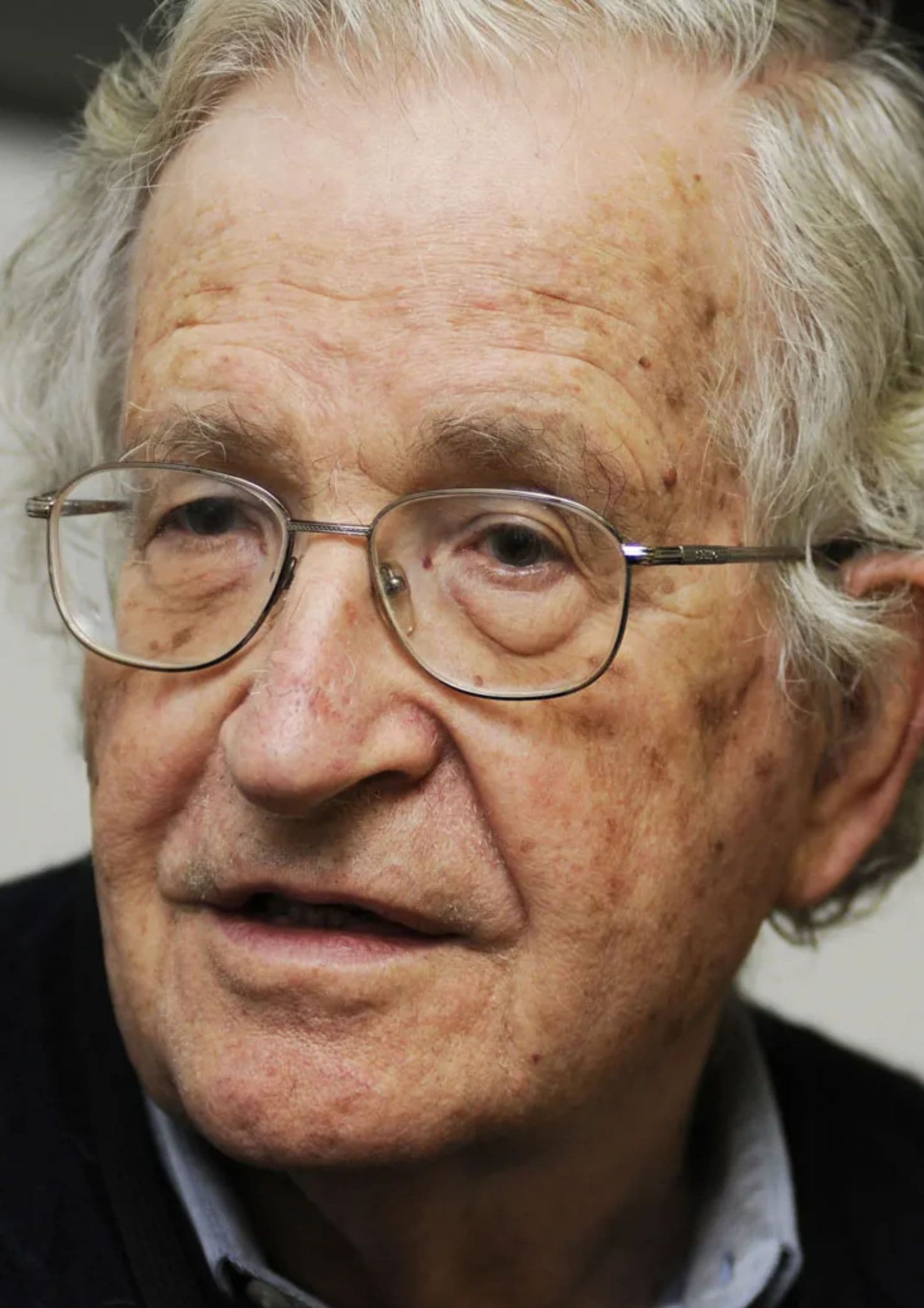 Close-up portrait photograph of Noam Chomsky, American linguist and political critic known for his theories on language and media (1)