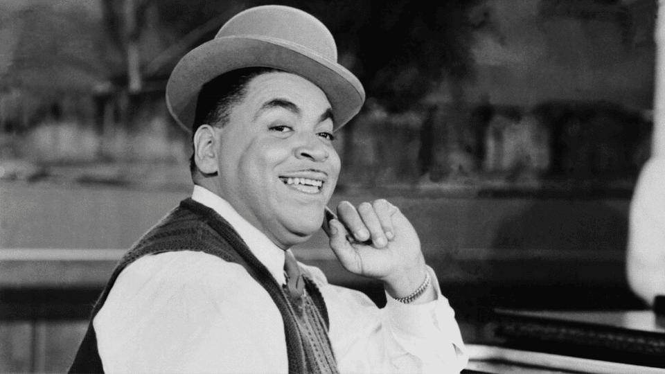Fats Waller playing piano happily