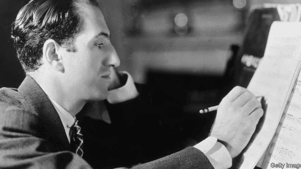 George Gershwin reading music notes