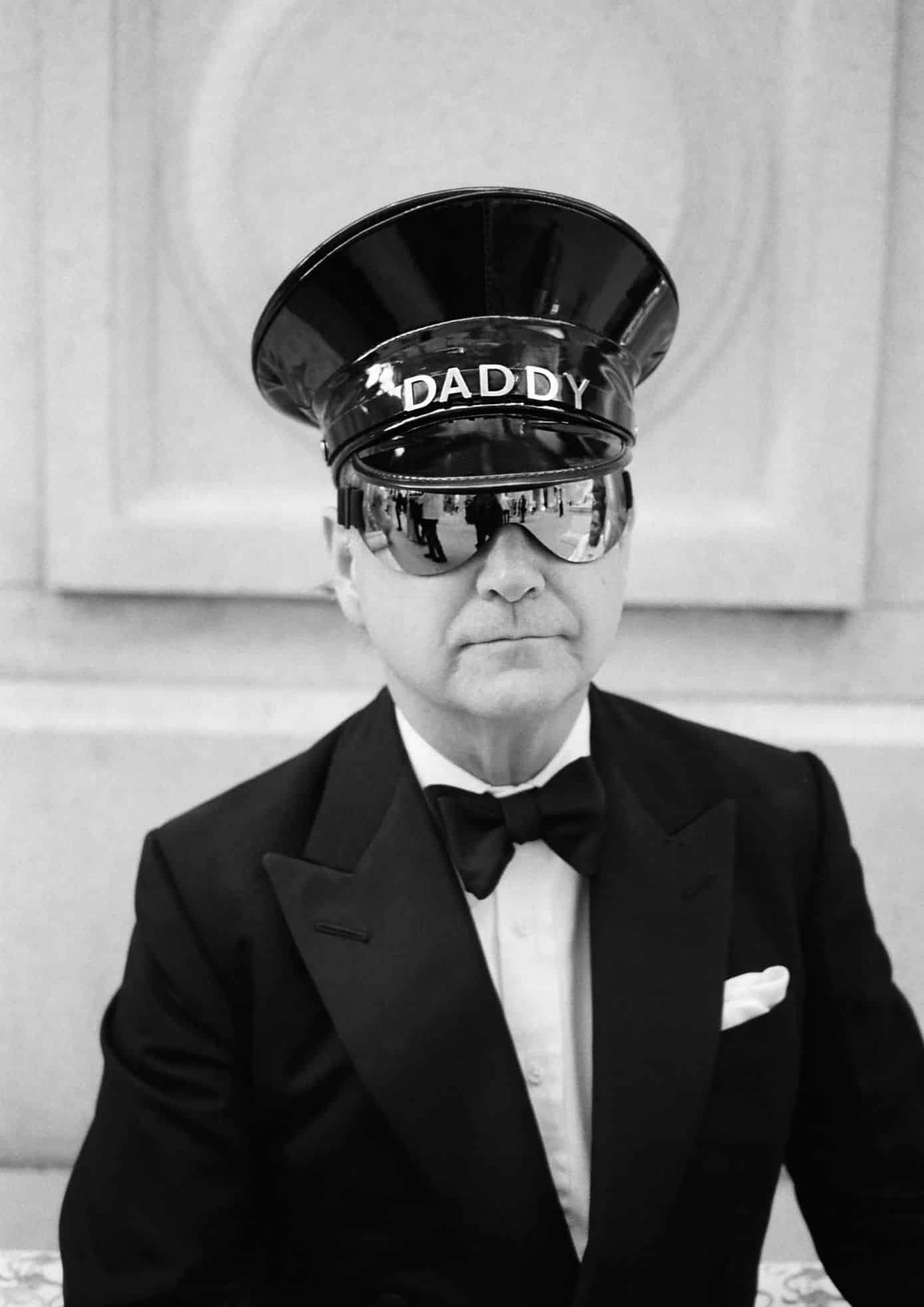 Jerry Hall in a tuxedo wearing a DADDY cap and sunglasses at the event.