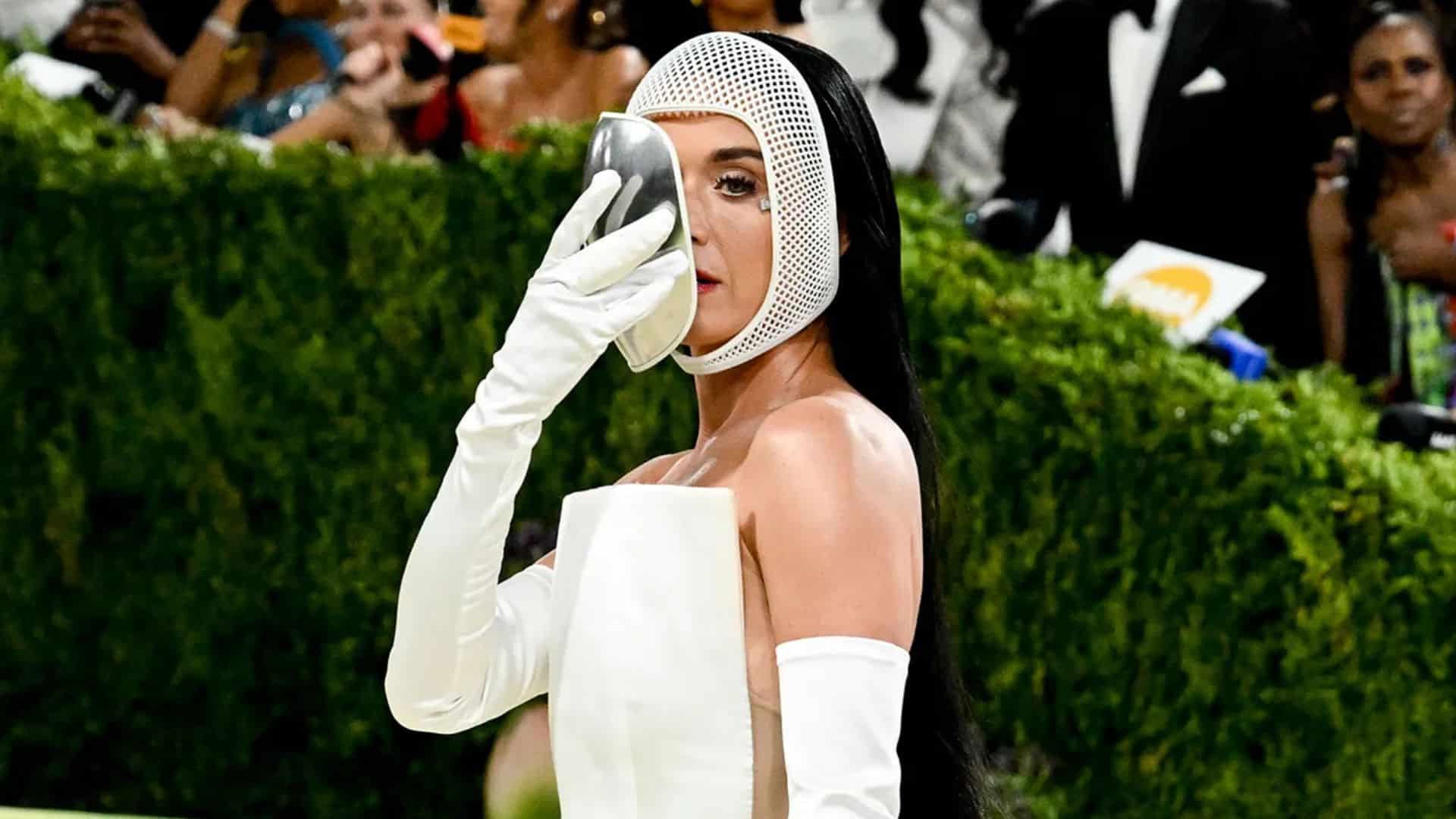 Katy Perry wearing a futuristic white avant-garde look with opera gloves and sculptural headpiece