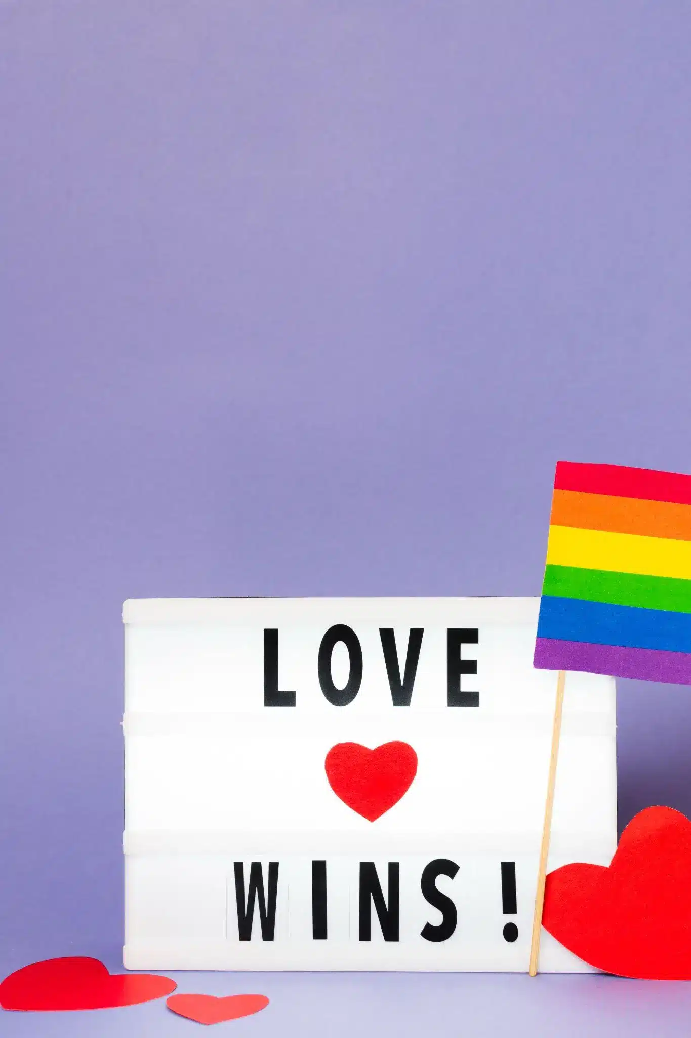 Lightbox with "Love Wins" text and rainbow flag on purple background