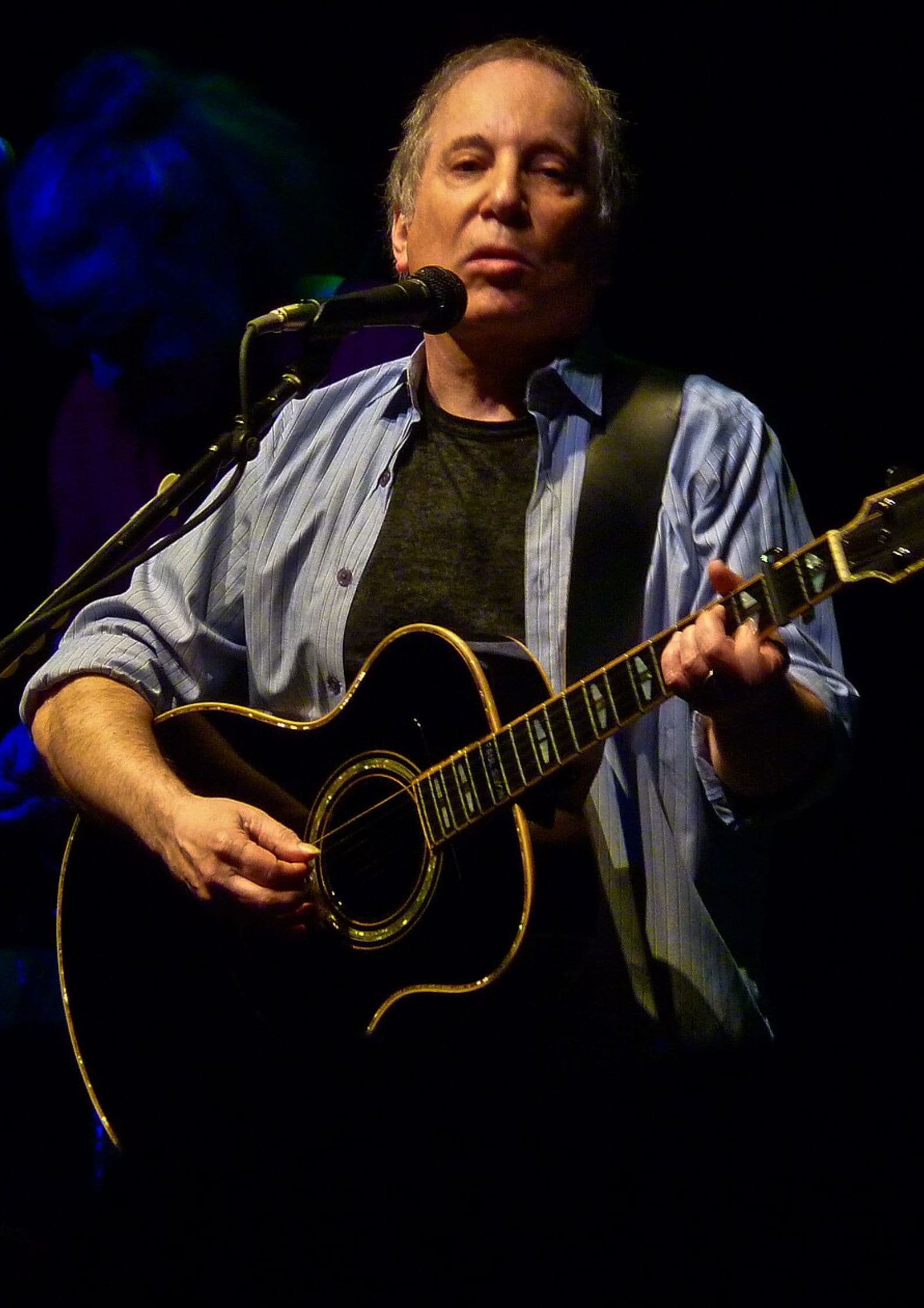 Paul Simon performing live on stage with an acoustic guitar, American Jewish singer-songwriter known for Simon and Garfunkel and the album Graceland (1)