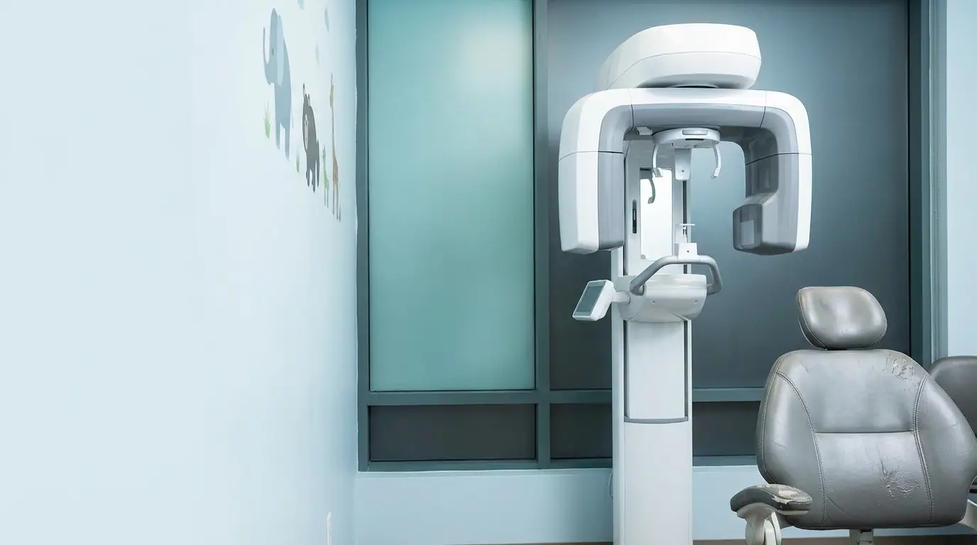Dental X-ray machine and chair in a brightly lit dental office with animal wall art