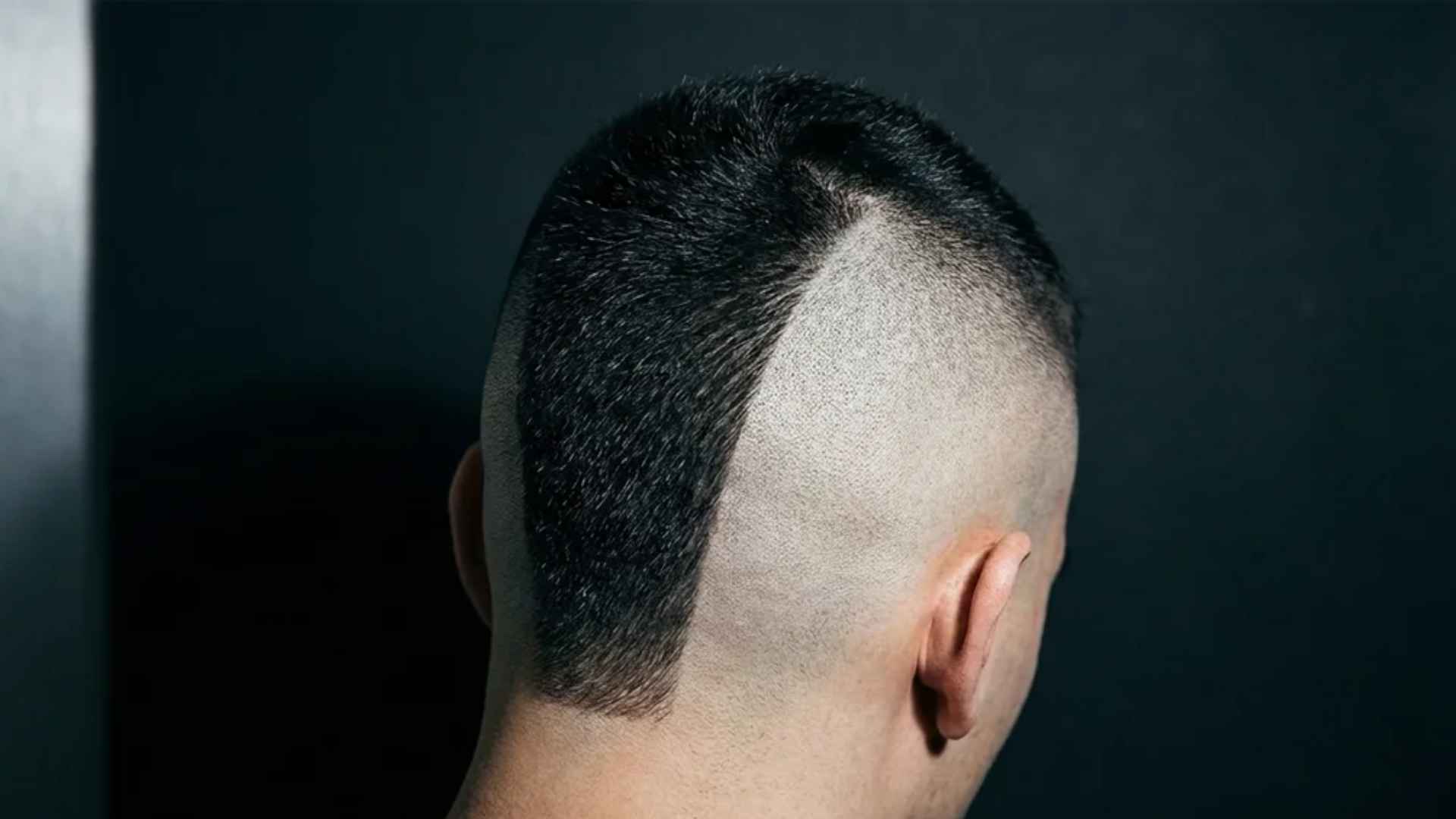 Defined Mohawk central strip above a skin fade with sharply shaved sides.