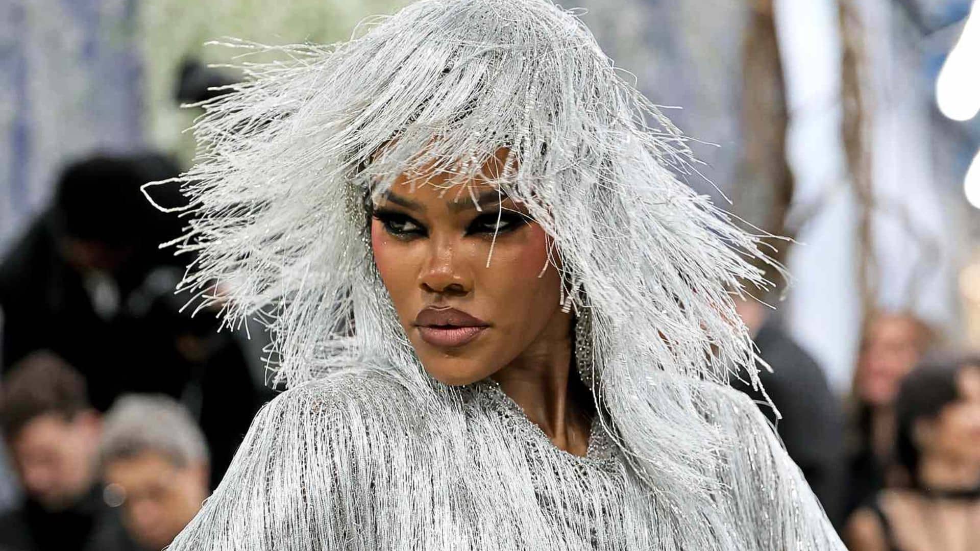 Teyana Taylor wearing a shimmering silver fringe Tom Ford look with dramatic textured headpiece at the Met Gala