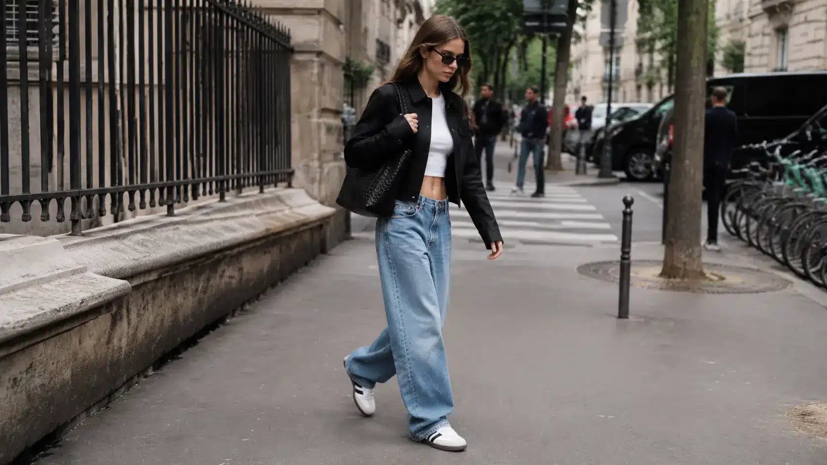 Woman styling Adidas Sambas with trendy minimalist streetwear outfit