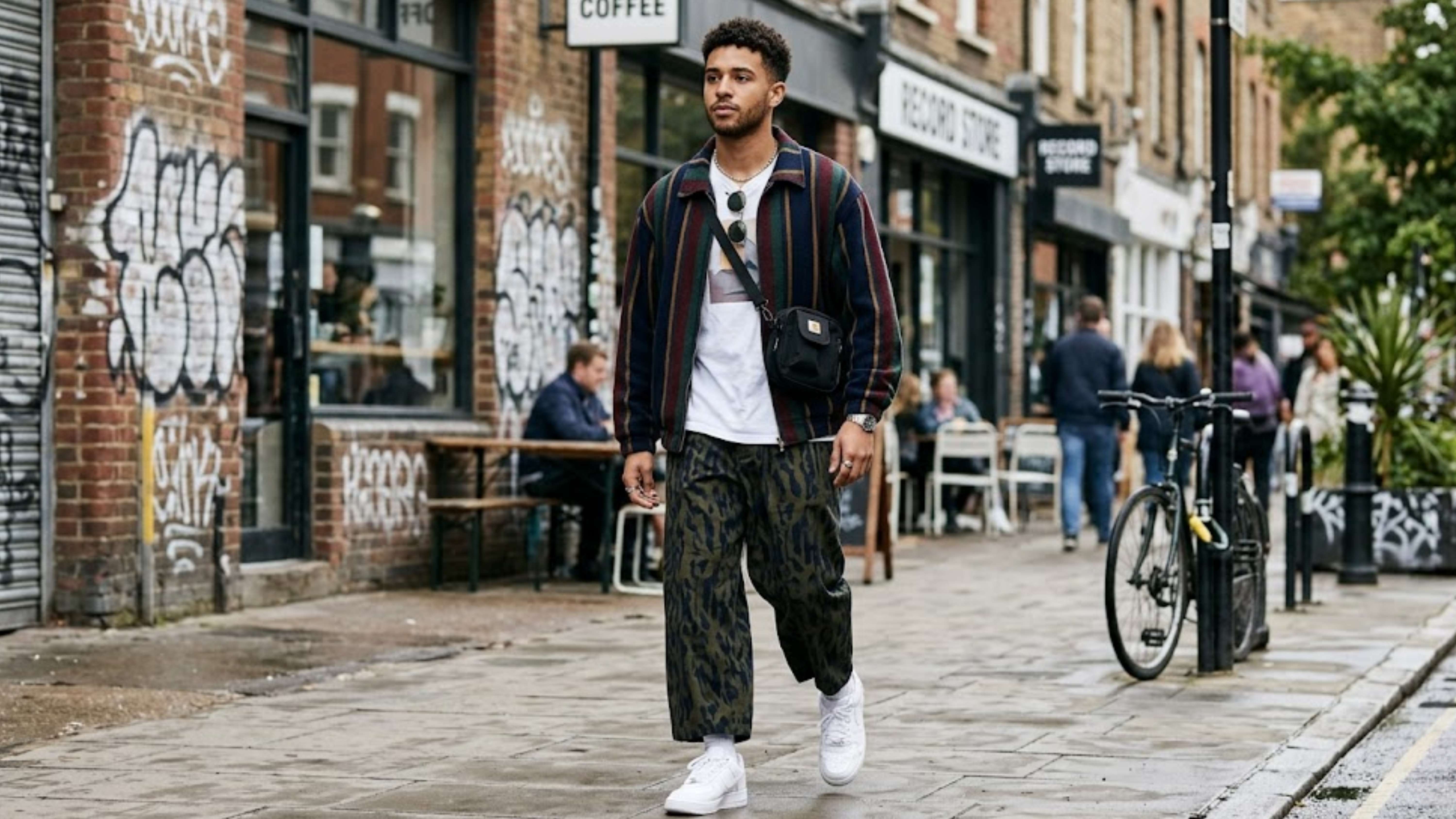 young-man-wearing-coordinated-mixed-pattern-streetwear-with-an-oversized-striped-jacket-and-wide-leg-pants
