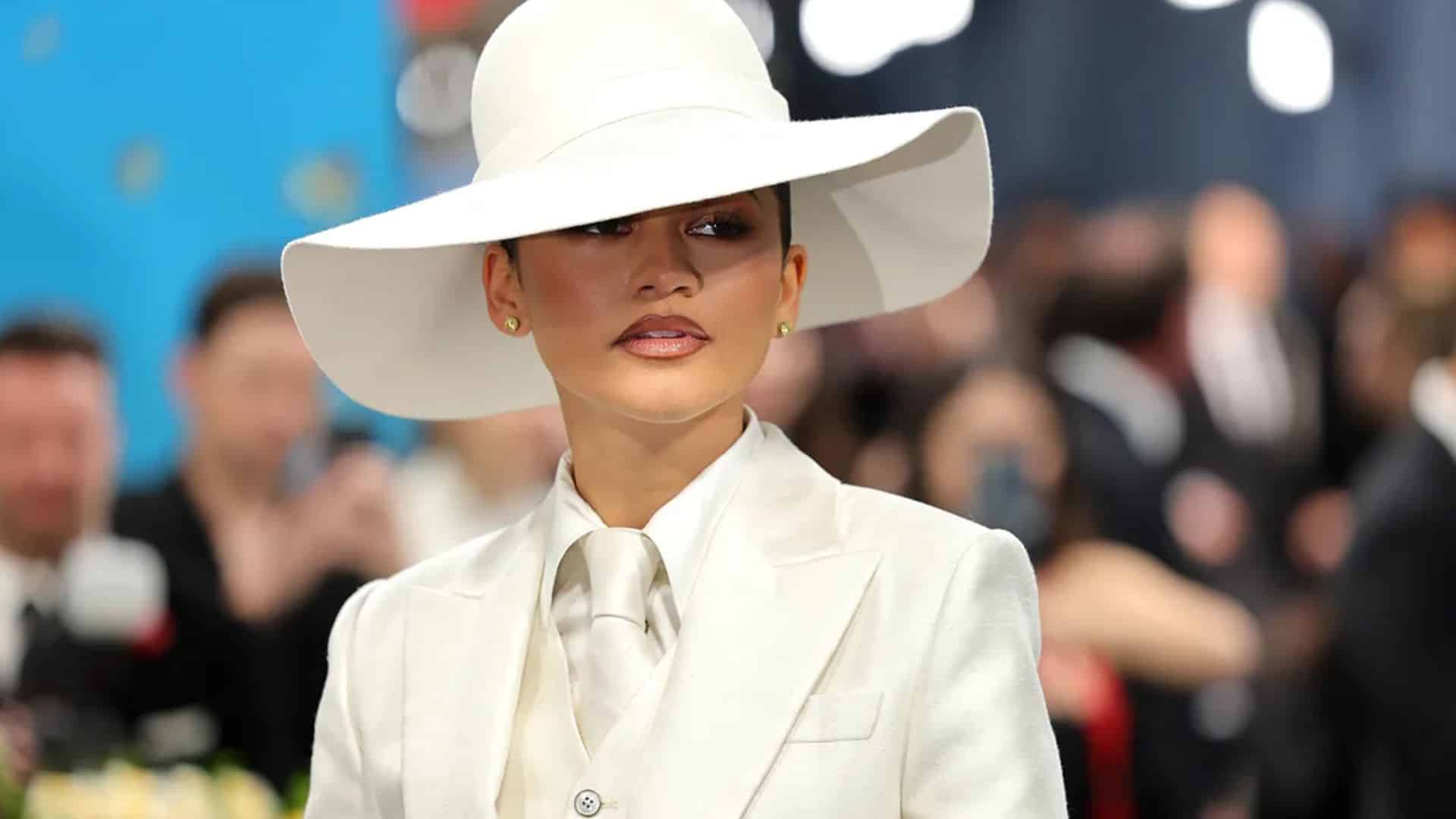 Zendaya wearing a sharp white Louis Vuitton suit with oversized wide-brim hat at the Met Gala 2026