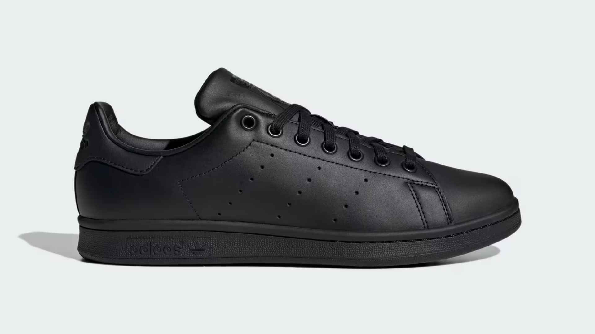 Adidas Stan Smith leather sneakers with heel tab minimal office style.