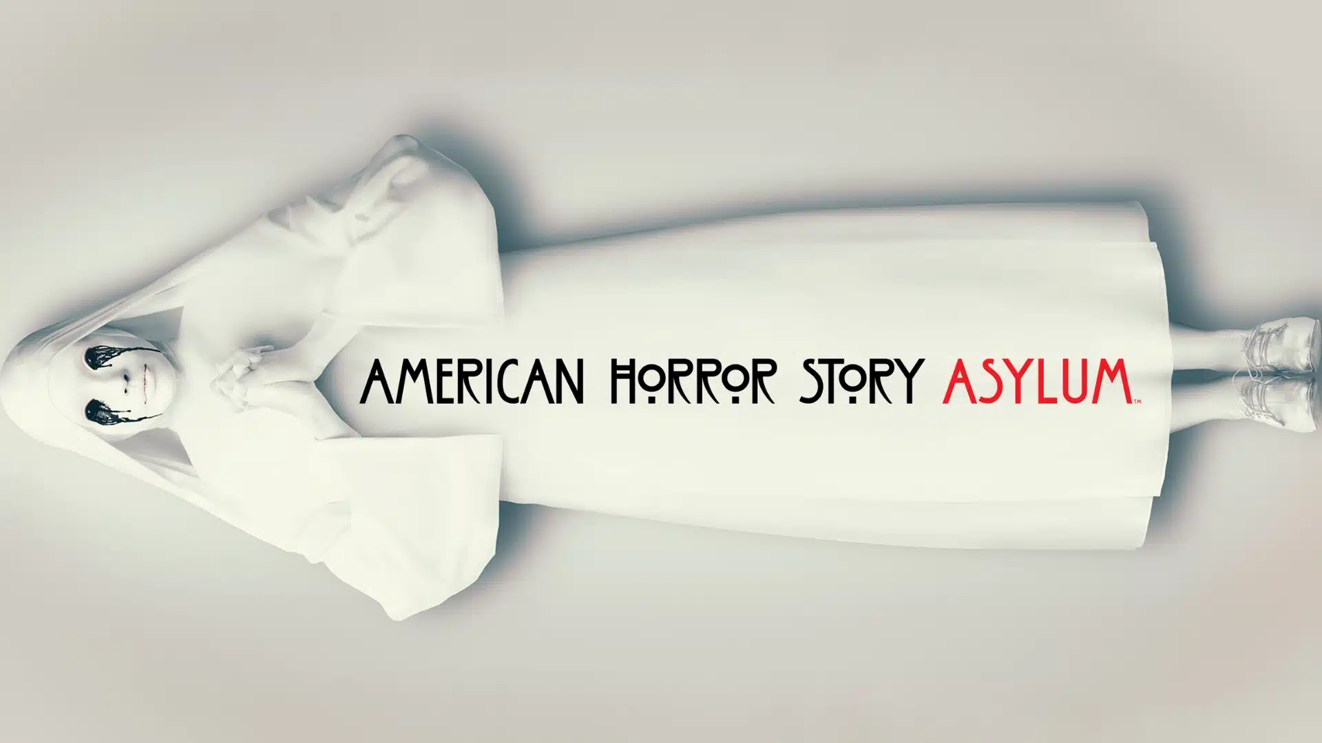Promotional poster for American Horror Story Asylum showing pale figure in white hospital gown lying sideways with title text.