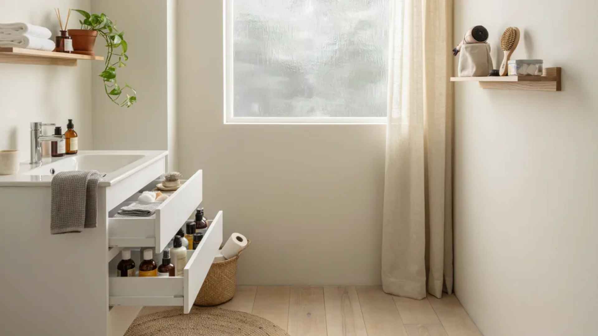 Minimalist bathroom tidy with organized cabinets, drawers, countertops, and shelves, clean and clutter-free.