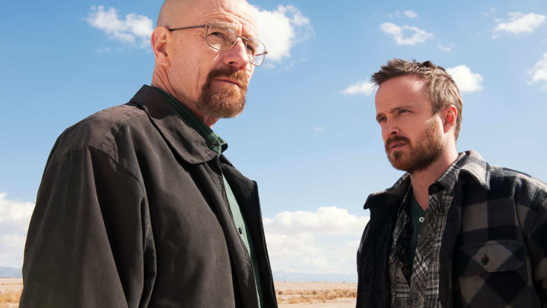 Cinematic still from *Breaking Bad* showing a tense moment involving the main character in a desert landscape, capturing the show’s dramatic and high-stakes atmosphere.