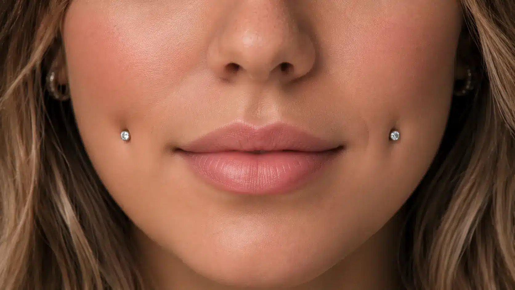 Cheek piercings with gemstone studs