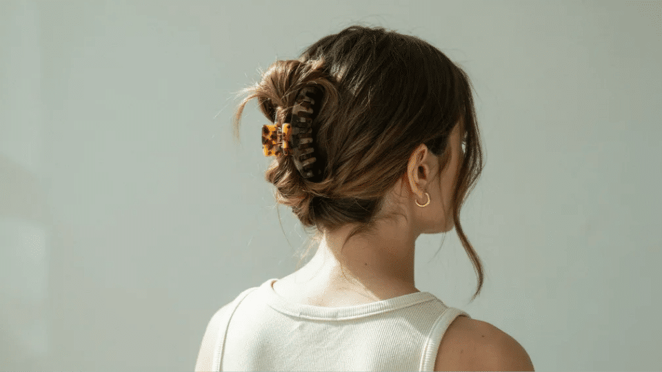 Loose claw clip twist bun with soft messy strands, relaxed Y2K inspired casual updo hairstyle look