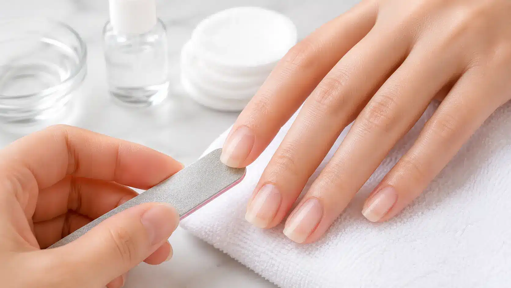 Fine-grit nail buffer removing leftover nail glue residue